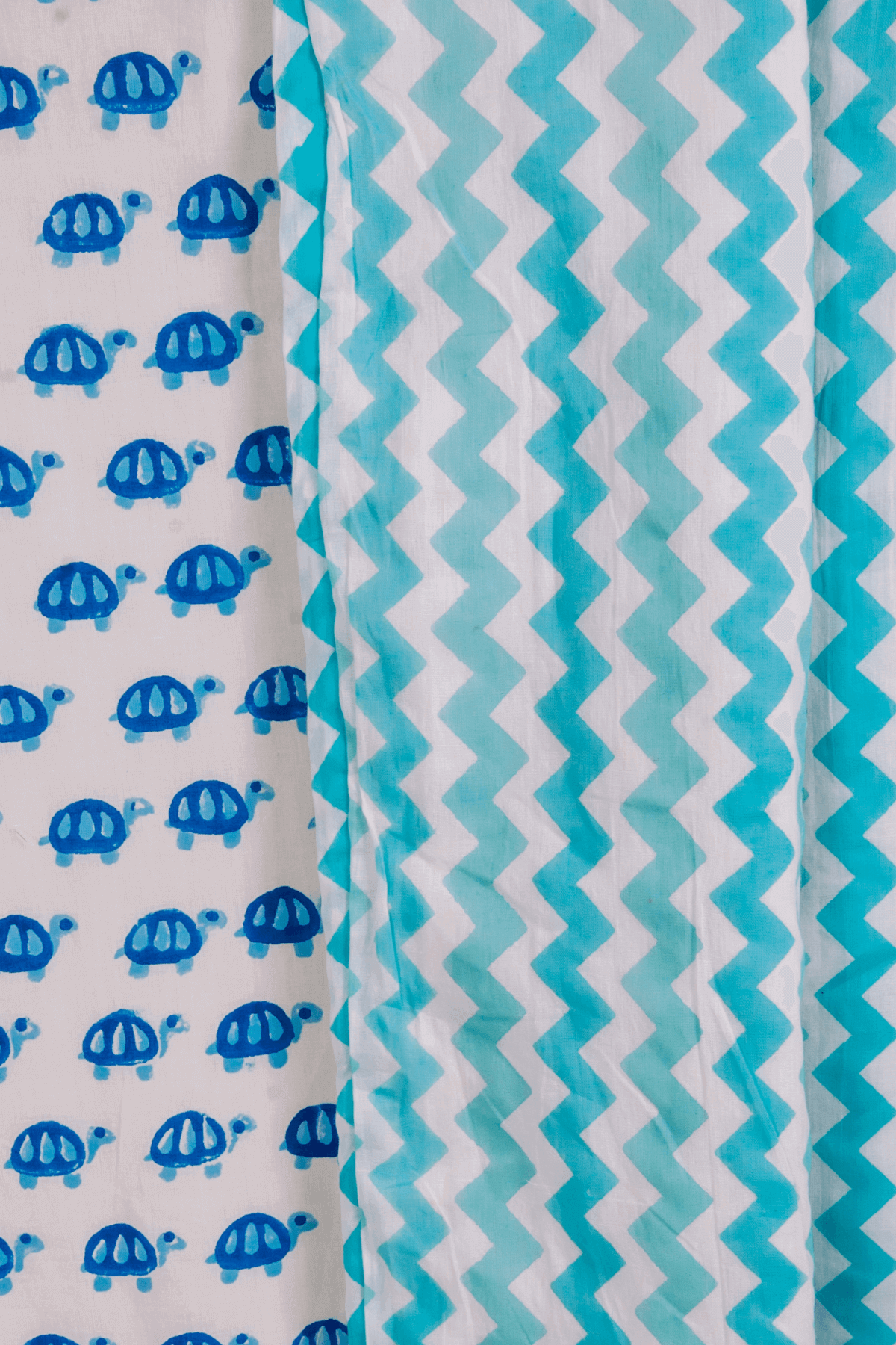 Close-up of tiny blue turtles hand block printed on soft cotton mulmul dohar