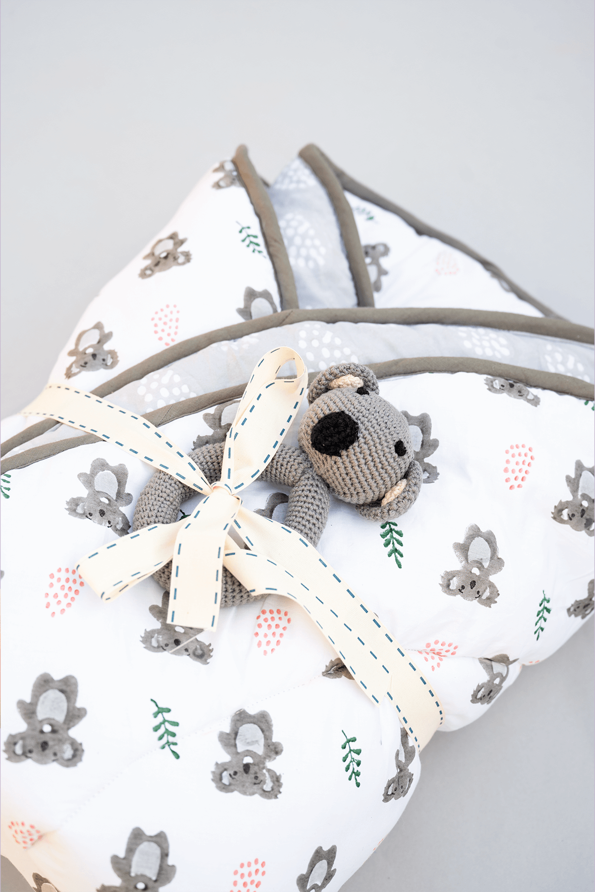 Folded koala print cotton baby playmat showing extra padding