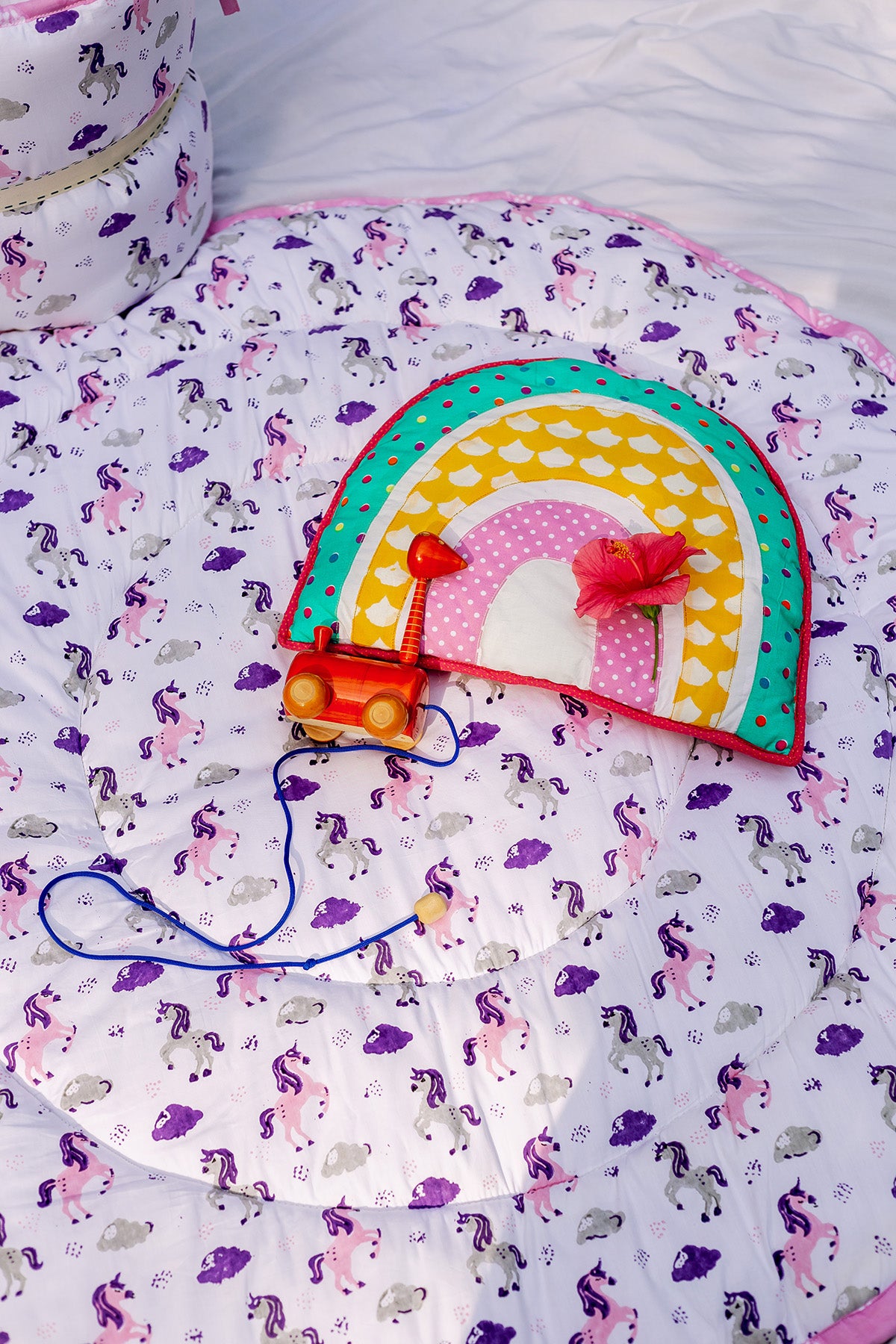 Reversible unicorn print padded cotton playmat showing the reverse side