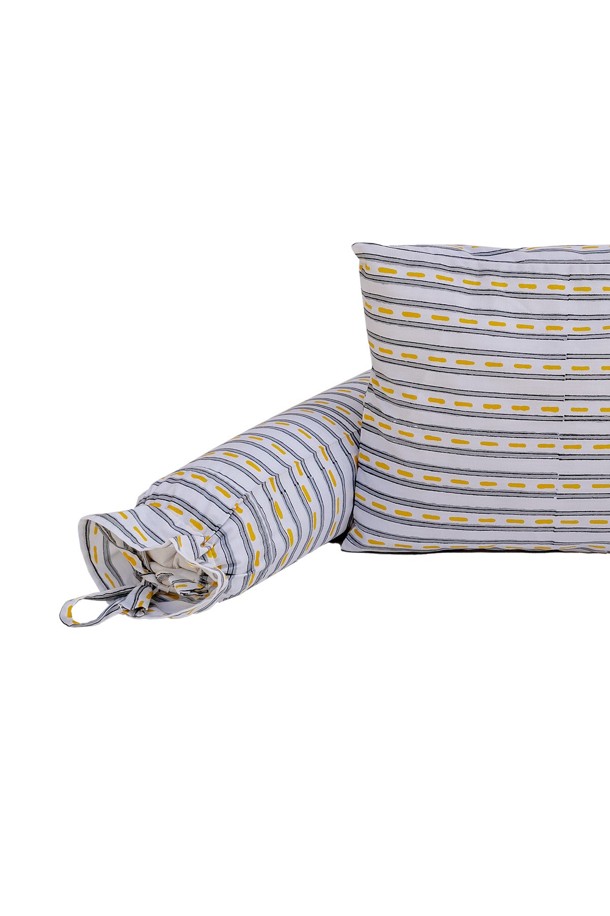 Close-up of road stripe print cotton baby bolster with tie-up ends beside matching pillow